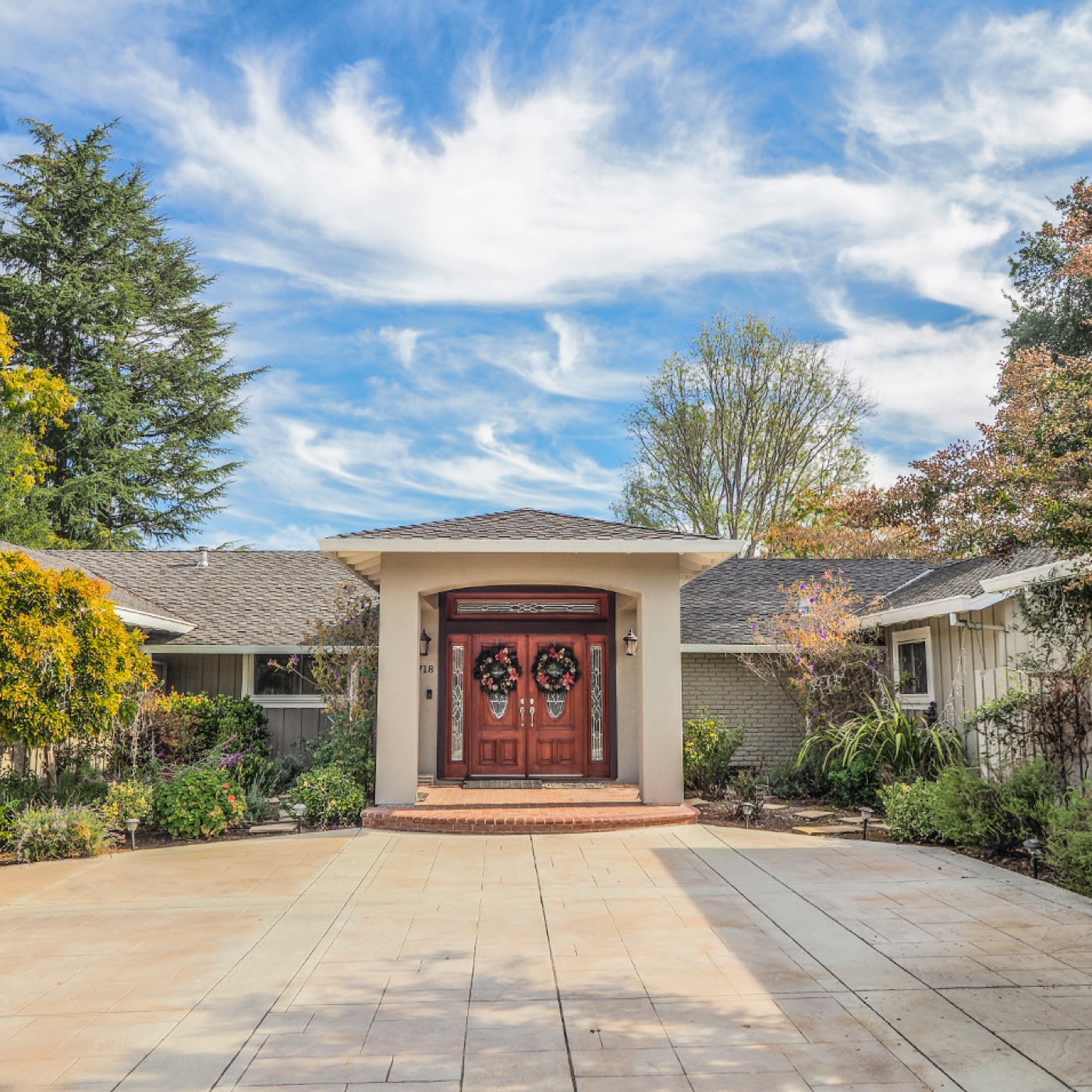 Custom home exterior with stamped concrete driveway in Silicon Valley